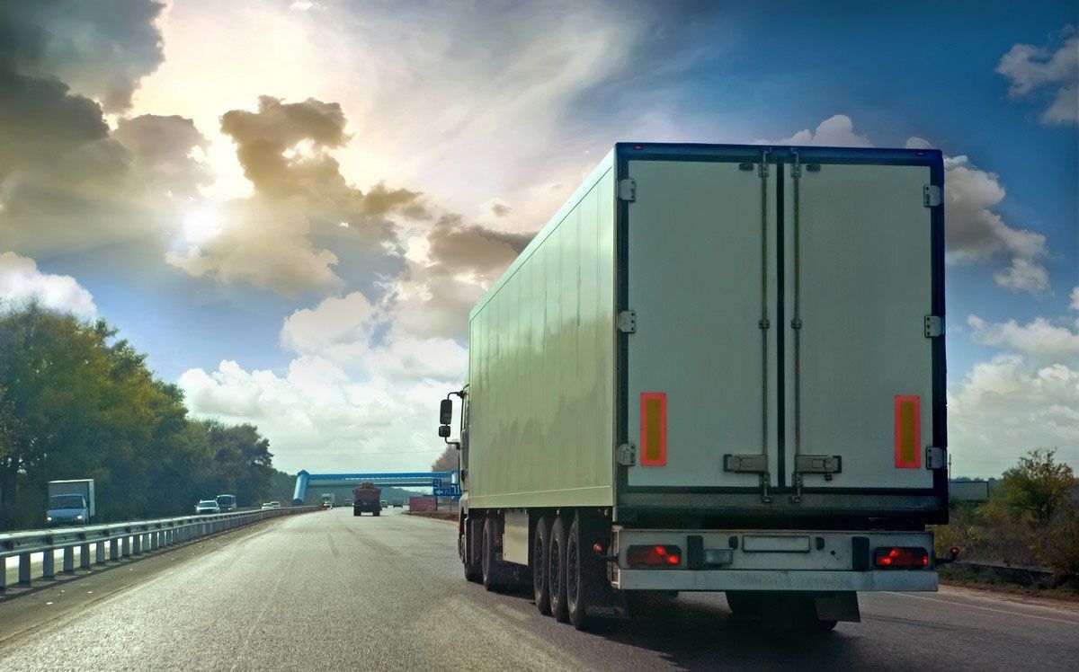 Mechanic running computer diagnostics on semi truck