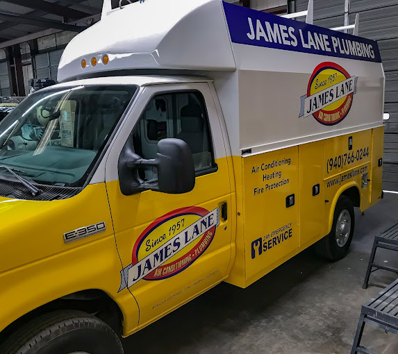 A fleet of commercial cargo vans with matching vinyl graphics